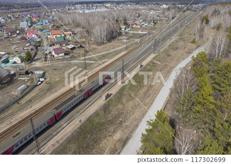 Aerial view of the train on railway tracks near the village of Baryshevo in Russia Aerial view of the train on railway tracks near the village of Baryshevo in Russia 117302699