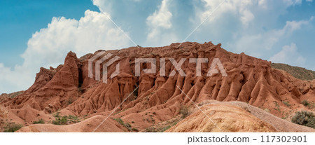 Unique and colorful rock formations in Skazka Fairytale Canyon, shaped over time by wind and water erosion, creating a stunning natural landscape. Issyk-Kul region, Kyrgyzstan. 117302901