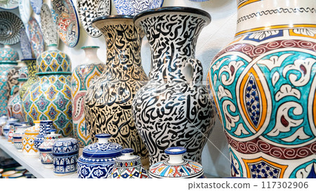 Colorful Moroccan pottery and ceramics displayed outside shops in the souks, showcasing traditional designs and craftsmanship. 117302906