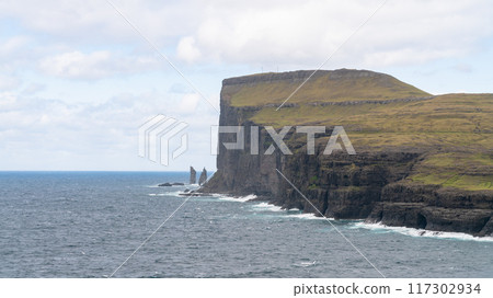 Risin and Kellingin sea rocks off the coast of the Faroe Islands. Risin and Kellingin sea rocks off the coast of the Faroe Islands. 117302934