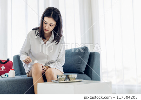 Woman Self healing perform first aid injury after she has been an accident 117304205