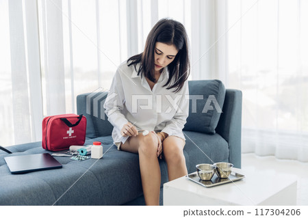 Woman Self healing perform first aid injury after she has been an accident Woman Self healing perform first aid injury after she has been an accident 117304206