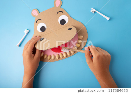 Educational paper craft featuring a hippo shape with toothbrush puppet, crafted from cardboard, perfect for children 117304653