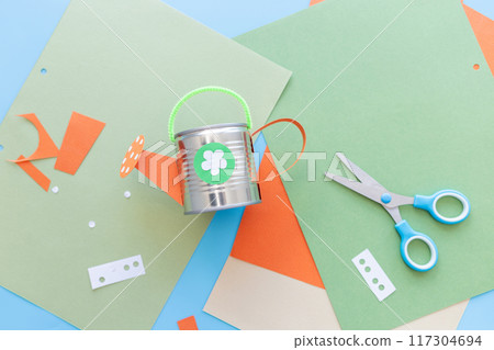 Papercraft with metal watering can on table, showcasing artistic and crafty elements in a playful and educational setting Papercraft with metal watering can on table, showcasing artistic and crafty elements in a playful and educational setting 117304694