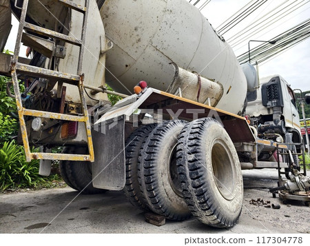 A concrete mixer truck parked beside of a concrete factory 117304778