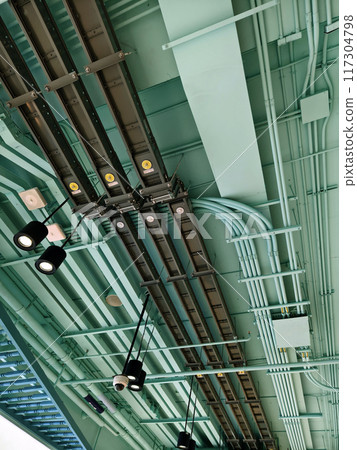 Ceiling with ventilation pipes and lights in industrial building Ceiling with ventilation pipes and lights in industrial building 117304798