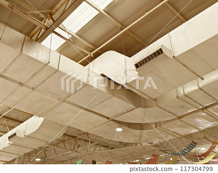 Ceiling with ventilation pipes and lights in industrial building Ceiling with ventilation pipes and lights in industrial building 117304799
