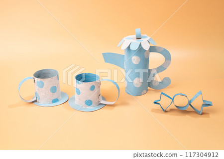 Coloring craft for kids, surreal tea party scene with paper modeling art featuring a couple of cups and a teapot papercraft Coloring craft for kids, surreal tea party scene with paper modeling art featuring a couple of cups and a teapot papercraft 117304912