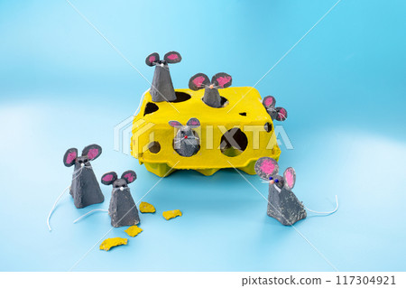 Creative craft project made from yellow egg carton, transformed into six mice 117304921