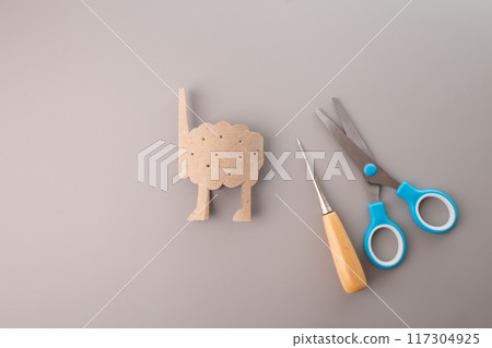 piece of artistry carved from a humble toilet paper roll, evoking the likeness of a sheep's body. The attention to detail is palpable as the cutout, piece of artistry carved from a humble toilet paper roll, evoking the likeness of a sheep's body. The attention to detail is palpable as the cutout, 117304925