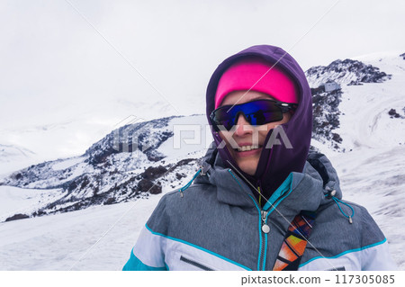 portrait of female mountaineer on the snowy slope of Mount Elbrus on the way to the top. portrait of female mountaineer on the snowy slope of Mount Elbrus on the way to the top. 117305085
