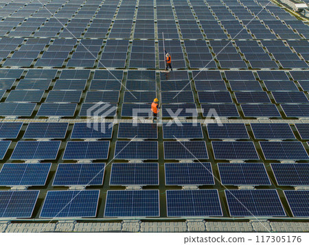 Worker Cleaning floating solar panels or solar cell Platform system on the lake with brush and water Worker Cleaning floating solar panels or solar cell Platform system on the lake with brush and water 117305176