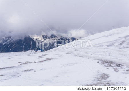 mountain shelters at an altitude about 4000 meters above sea level on the snowy slope of Mount Elbrus mountain shelters at an altitude about 4000 meters above sea level on the snowy slope of Mount Elbrus 117305320