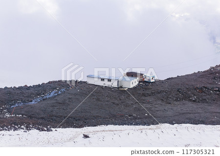 mountain shelters at an altitude about 4000 meters above sea level on the snowy slope of Mount Elbrus 117305321