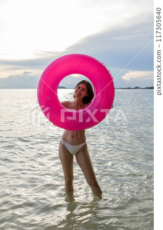 Beautiful girl on sun tanning in a tropical beach Beautiful girl on sun tanning in a tropical beach 117305640