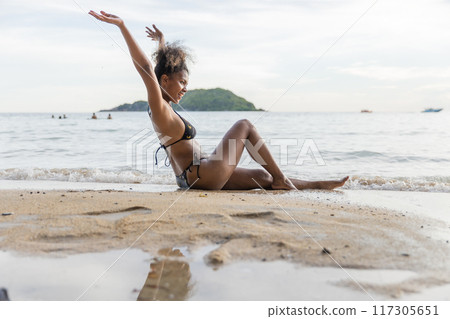 Beautiful girl on sun tanning in a tropical beach Beautiful girl on sun tanning in a tropical beach 117305651