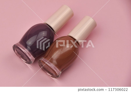 Nail polish small glass bottles on pink background, professional manicure concept 117306022