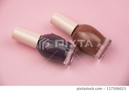 Nail polish small glass bottles on pink background, professional manicure concept 117306023