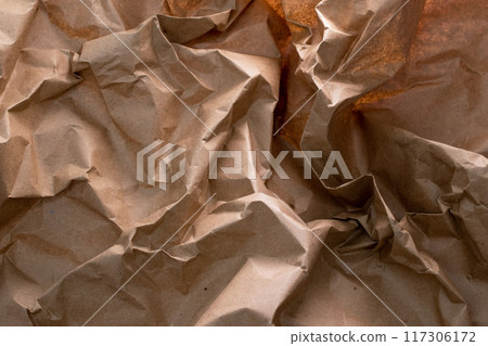 A crumpled craft paper background, symbolizing the essence of recycling - an eco-friendly reminder of reusing and reducing waste, blending sustainability with texture and character. 117306172
