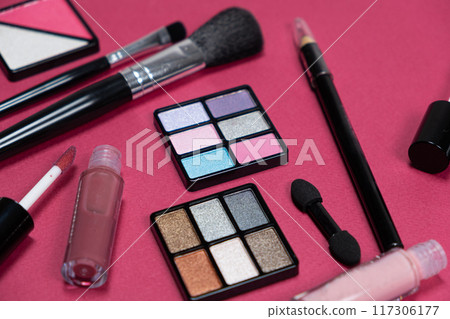 Various decorative cosmetics and brushes on a pink background 117306177