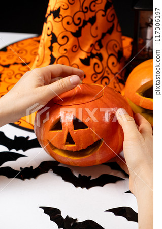Creating a Hokkaido pumpkin jack-o'-lantern for Halloween. Creating a Hokkaido pumpkin jack-o'-lantern for Halloween. 117306197