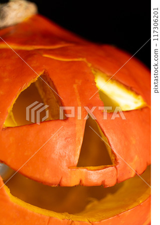 Halloween pumpkin glowing jack-o-lantern on a black background. Halloween Sale 117306201
