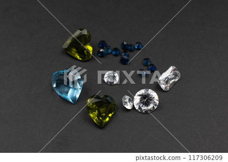 Colorful faceted gemstones on black background, heart shaped crystal gems 117306209