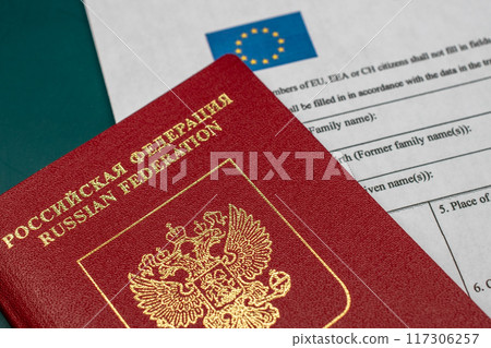 Russian travel passport with Schengen visa application form, sanctions, emigration, immigration, tourism concept Russian travel passport with Schengen visa application form, sanctions, emigration, immigration, tourism concept 117306257