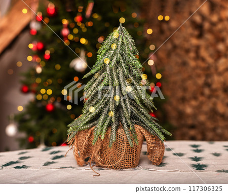 small Christmas tree on holiday table, winter decoration 117306325