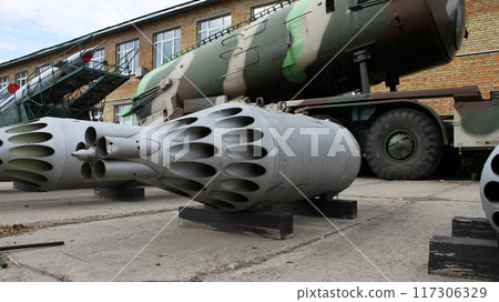 Damaged Cassette Of Aircraft Rockets In Front Of Anti-Aircraft Missile Launcher Damaged Cassette Of Aircraft Rockets In Front Of Anti-Aircraft Missile Launcher 117306329