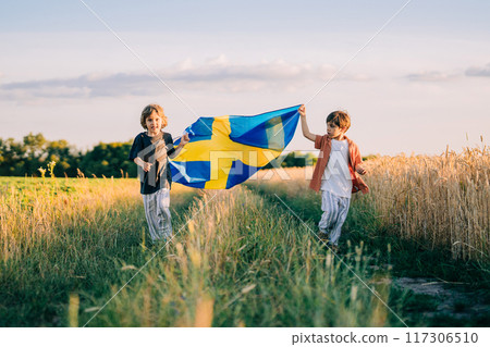 Swedish Little Kids - Patriot Children Runs With National Flag On Nature Swedish Little Kids - Patriot Children Runs With National Flag On Nature 117306510