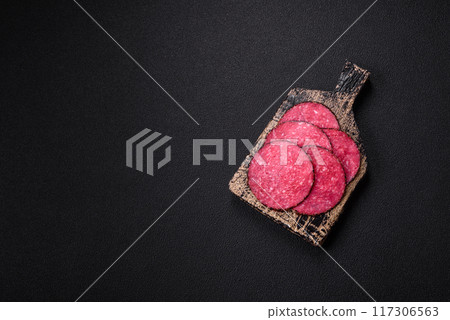 Delicious smoked salami sausage sliced with salt, spices and herbs Delicious smoked salami sausage sliced with salt, spices and herbs 117306563
