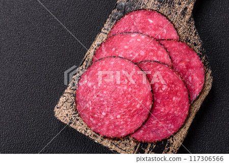 Delicious smoked salami sausage sliced with salt, spices and herbs Delicious smoked salami sausage sliced with salt, spices and herbs 117306566