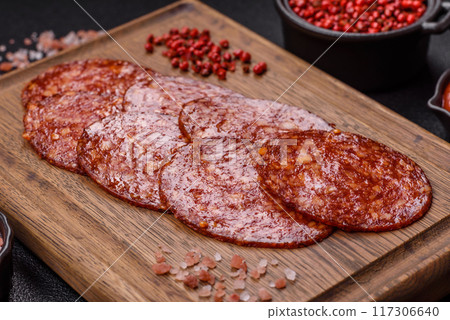 Delicious smoked pepperoni sausage sliced with salt, spices and herbs Delicious smoked pepperoni sausage sliced with salt, spices and herbs 117306640