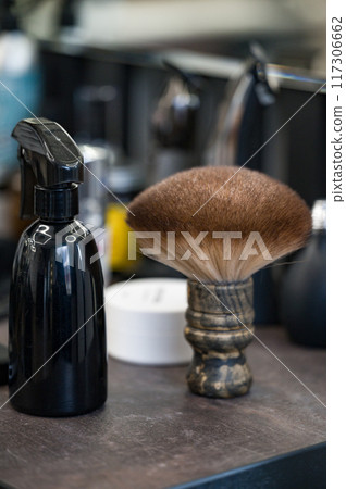A beard brush next to a sprayer close-up in a barbershop 117306662