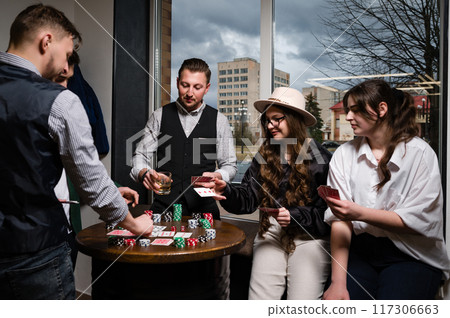 A team of young boys and girls play poker. First-person observation of card poker from various close-up angles. A team of young boys and girls play poker. First-person observation of card poker from various close-up angles. 117306663
