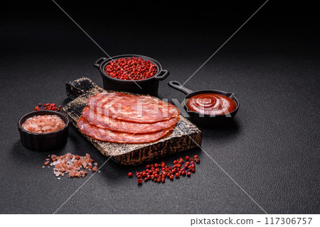 Delicious smoked meat sliced with salt, spices and herbs 117306757