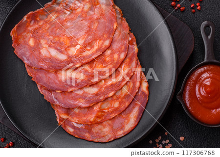 Delicious smoked meat sliced with salt, spices and herbs 117306768