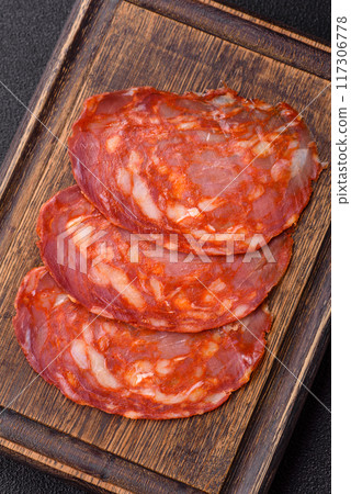 Delicious smoked meat sliced with salt, spices and herbs Delicious smoked meat sliced with salt, spices and herbs 117306778