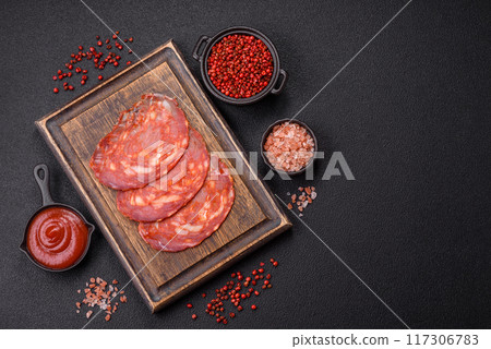Delicious smoked meat sliced with salt, spices and herbs Delicious smoked meat sliced with salt, spices and herbs 117306783