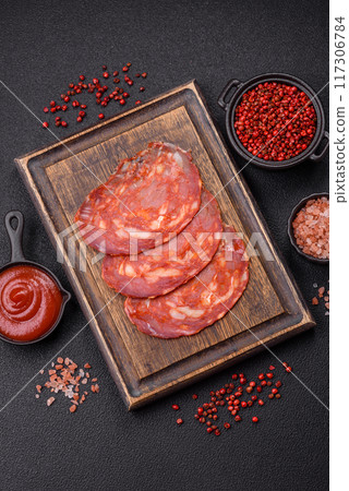 Delicious smoked meat sliced with salt, spices and herbs 117306784