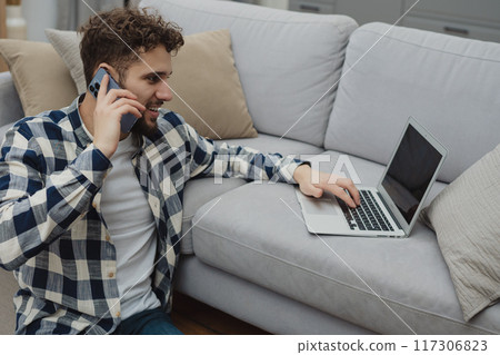 Businessman working at home on paperwork. Businessman working at home on paperwork. 117306823