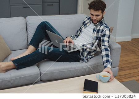 Businessman working at home on paperwork.  117306824