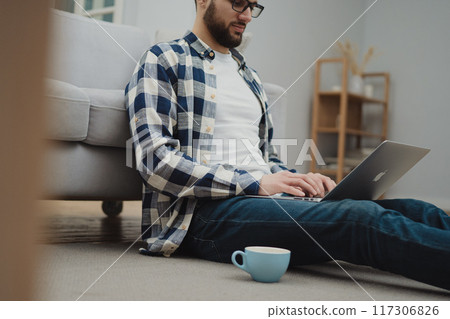 Businessman working at home on paperwork.  117306826