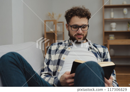 Businessman working at home on paperwork.  117306829