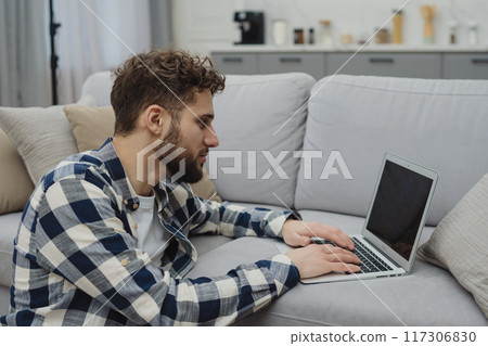 Businessman working at home on paperwork.  117306830