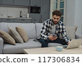 Businessman working at home on paperwork.  117306834