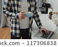 Businessman working at home on paperwork.  117306838