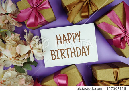 Happy Birthday card with gift box presents on purple background Happy Birthday card with gift box presents on purple background 117307116