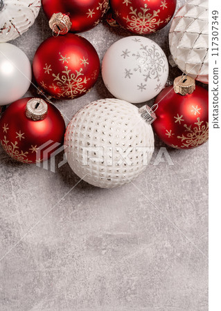 Red and white Christmas baubles border flat lay. Merry Christmas and Happy New Year seasons greetings card. Copy space. Festive border 117307349